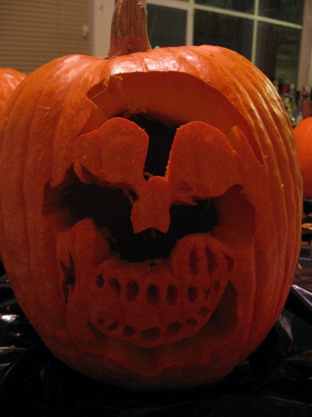 1989 Ford Bronco - A carved pumpkin displays a spooky skull face, ready for Halloween.