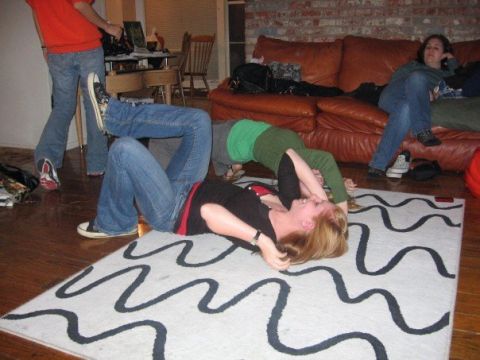 1989 Ford Bronco - People practice yoga indoors on a patterned rug in a living room setting.