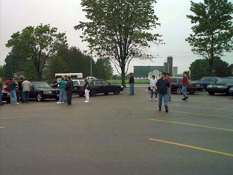 Black 2000 Ford Crown Victoria, side view, parked in a lot