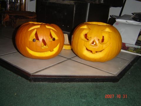 1993 Ford Bronco - Two carved pumpkins with illuminated faces are displayed on a tiled surface, likely for Halloween.