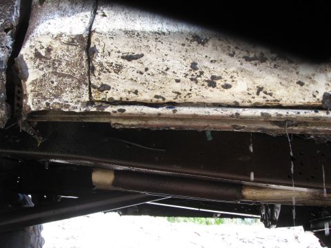 1979 Ford F-150 - The underside of the vehicle shows significant rust and wear on the frame and components.