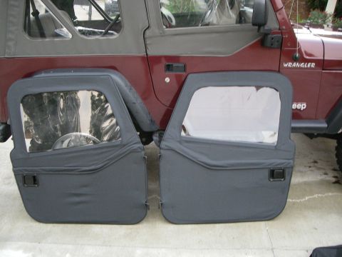 1995 Ford Bronco - Soft doors for a Jeep Wrangler are shown next to the vehicle. The model year is estimated to be around 1997.