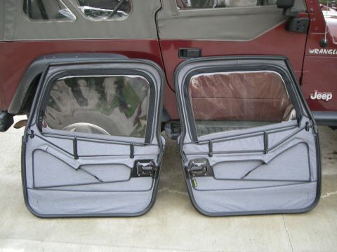 1995 Ford Bronco - A pair of soft doors, likely for a Jeep Wrangler, are shown removed from the vehicle.