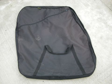1995 Ford Bronco - A black car cover with two handles is shown lying flat on a concrete surface.