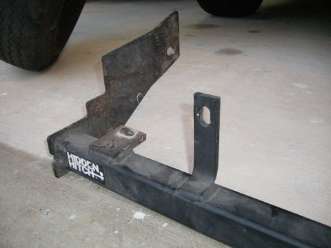 1995 Ford Bronco - A black trailer hitch with the "HIDDEN HITCH" logo is shown on a concrete floor.