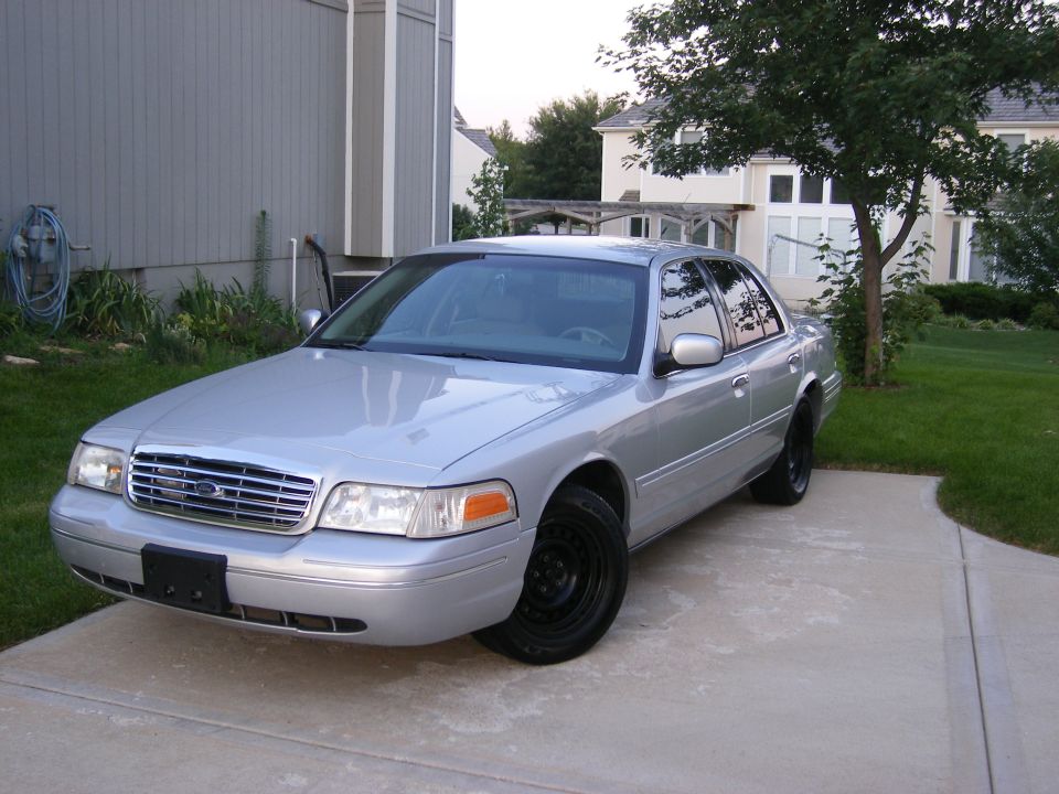 Silver 2001 Ford Crown Victoria sedan parked on a concrete driveway