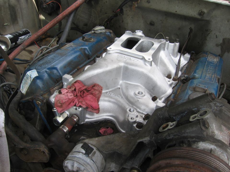 Aluminum Edelbrock intake manifold installed on a Ford V8 with blue valve covers