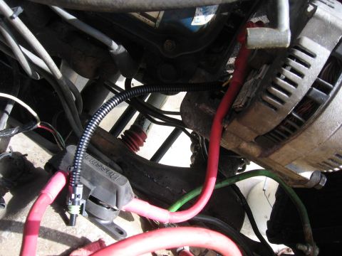 1979 Ford F-150 - Close-up view of an alternator and various wires within an engine bay. Some text is visible on a component.