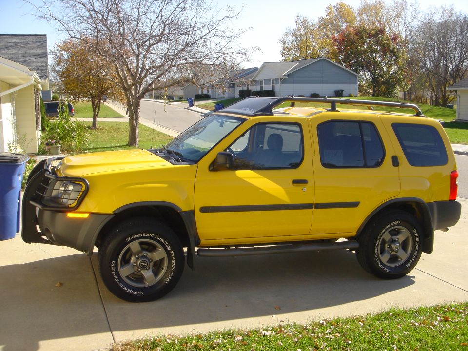 Yellow 2003 Nissan Xterra parked on driveway