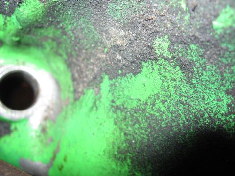 1979 Ford F-150 - This is a close-up view of a dirty engine component with chipped green paint.