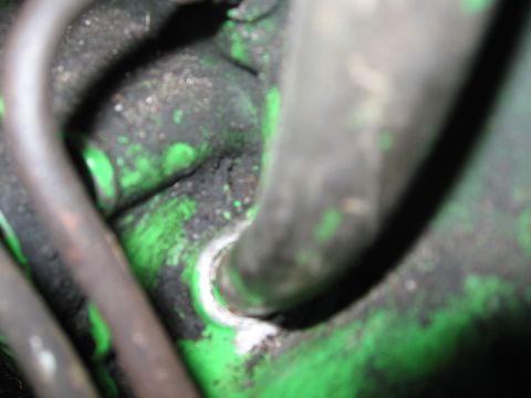 1979 Ford F-150 - This image shows a close-up of a greasy green engine component with dark hoses, not a 1979 Ford F-150 transmission.