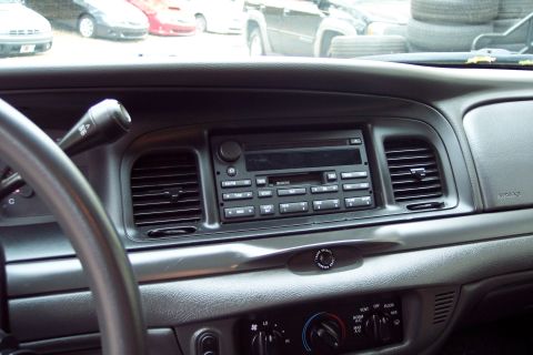 2001 Ford Crown Victoria - Dashboard view of a car's interior, including the steering wheel, radio, and air vents.