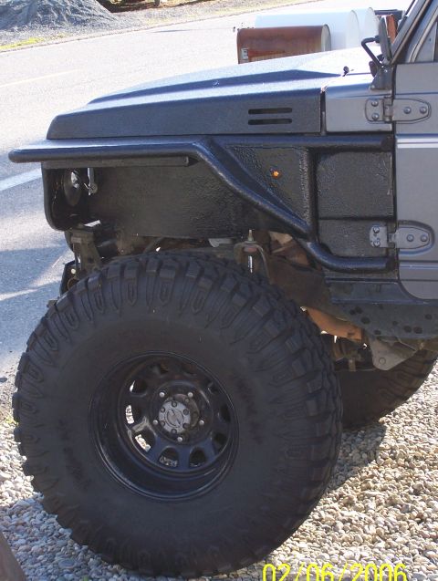 1988 Suzuki Samurai - Close-up view of the front fender and aggressive off-road tire on a 1988 Suzuki Samurai.