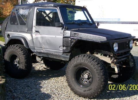 1988 Suzuki Samurai - This modified 1988 Suzuki Samurai features oversized tires and a custom soft top, ready for off-road adventures.