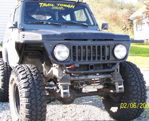 1988 Suzuki Samurai - This modified 1988 Suzuki Samurai features oversized tires and a custom front bumper, suggesting off-road capabilities.