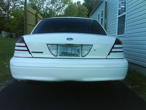 2003 Ford Crown Victoria - Rear end of a white Ford Crown Victoria in a driveway; Kentucky license plate reads 225 FXN.