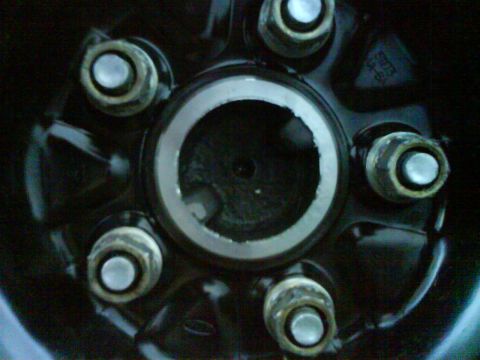 2003 Ford Crown Victoria - This is a close-up view of a vehicle's wheel hub, lug nut mounting points.