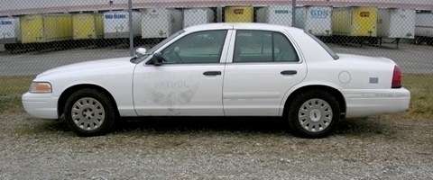 2003 Ford Crown Victoria - White 2003 Ford Crown Victoria police car with 'PATROL' text on the door.