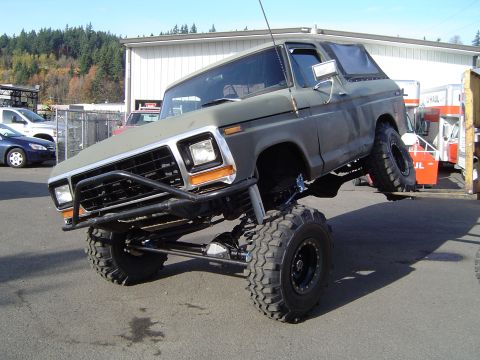 1978 Ford Bronco - Modified 1978 Ford Bronco on display with a significant suspension lift and large off-road tires.