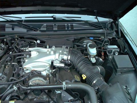 2000 Ford Crown Victoria - Engine bay view of a 2000 Ford Crown Victoria, showing the V8 engine and air intake system.