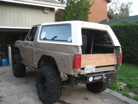 1989 Ford Bronco - This modified Ford Bronco features oversized tires and a custom wooden bed insert.