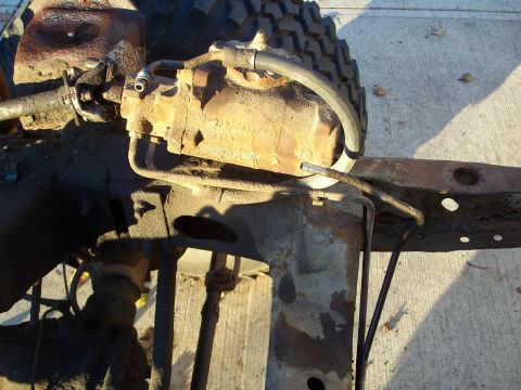 1979 Ford F-150 - This is a close-up view of a heavily rusted power steering gearbox assembly, likely from an older truck.