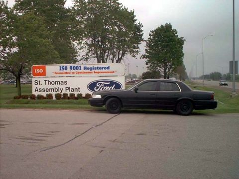 2000 Ford Crown Victoria - A black 2000 Ford Crown Victoria is parked near a sign for the St. Thomas Assembly Plant.