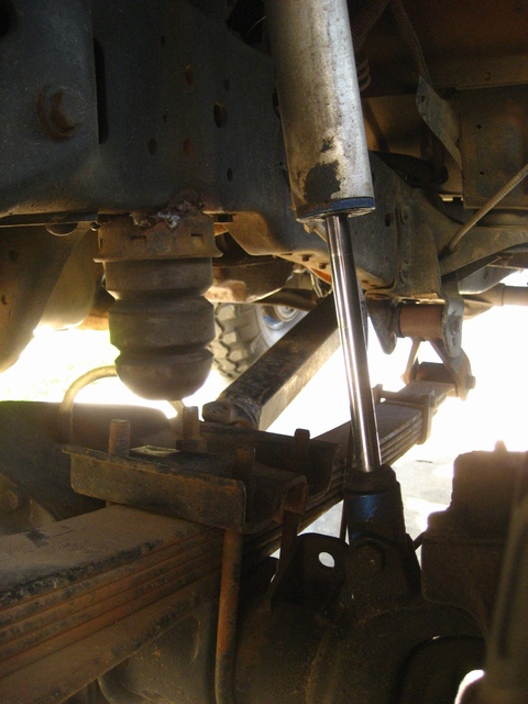 1989 Ford Bronco - Close-up view of the undercarriage of a truck, focusing on suspension components.
