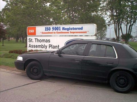 2000 Ford Crown Victoria - A black 2000 Ford Crown Victoria is parked in front of the St. Thomas Assembly Plant sign.