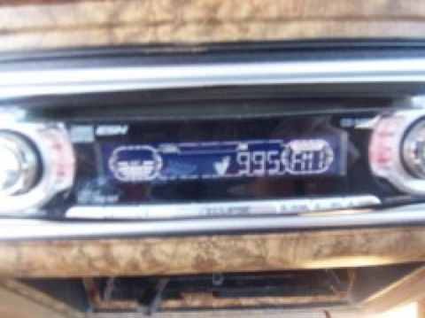 1986 Ford Bronco - Close-up of a car stereo's digital display showing radio station frequency.