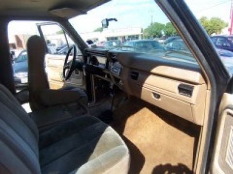 1986 Ford Bronco - Interior view of a 1980s Ford Bronco, showing the dashboard and seats.
