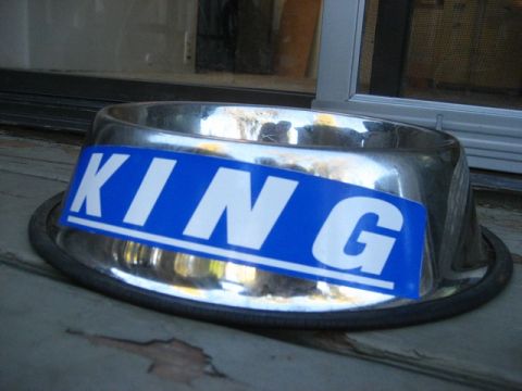 1989 Ford Bronco - A chrome dog bowl with a blue sticker displaying the word KING is shown close-up.