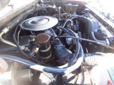 1986 Ford Bronco - The engine bay of a vehicle is shown, various hoses and the air filter assembly.