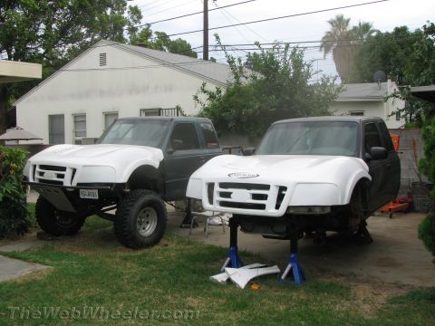 1968 Ford Mustang - Two Ford Rangers are shown in a yard, one modified for off-roading and the other on jack stands with new fenders.