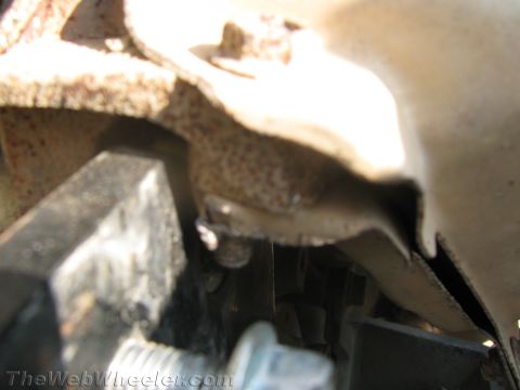 1987 Suzuki Samurai - A close-up view of a rusted metal component, possibly from a vehicle's undercarriage.
