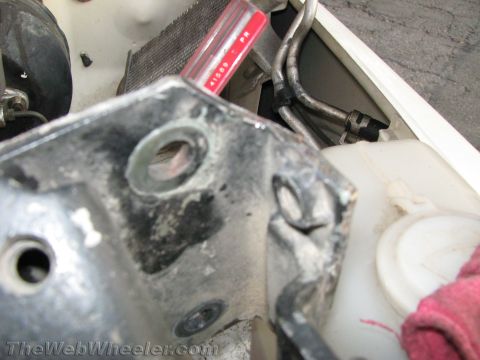 1987 Suzuki Samurai - Engine bay components are visible, including a metal bracket and radiator.