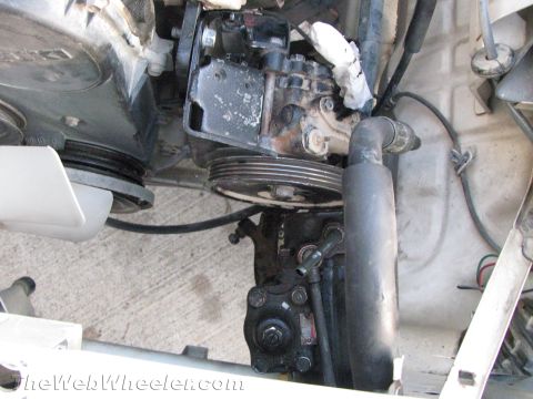 1987 Suzuki Samurai - Power steering pump and pulley assembly with associated hoses and belts.