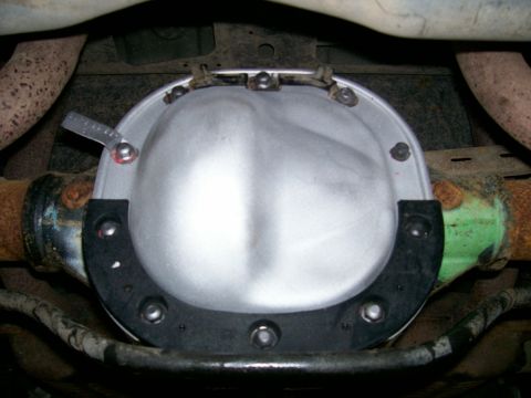 2001 Ford Crown Victoria - Close-up view of a vehicle's rear differential cover and axle housing.