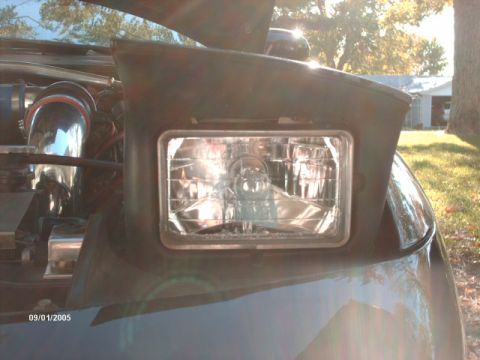 1995 Ford Probe - Close-up of the headlight and engine bay of a 1995 Ford Probe.