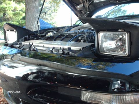 1995 Ford Probe - Front view of a 1995 Ford Probe's engine bay, hood up, revealing the engine components.