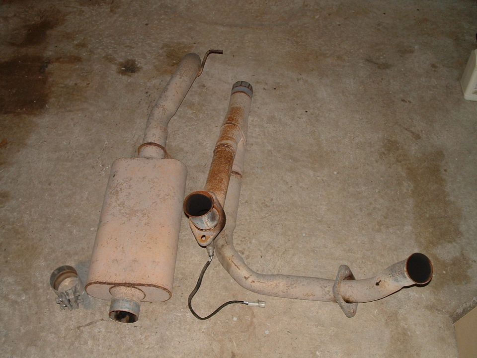 Exhaust system parts on concrete floor