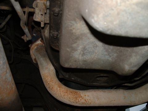 1995 Ford Bronco - Close-up of the undercarriage, showing the exhaust system and oil pan.
