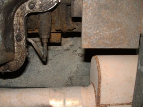 1995 Ford Bronco - Close-up view of the undercarriage, showing exhaust components and rusty metal parts.