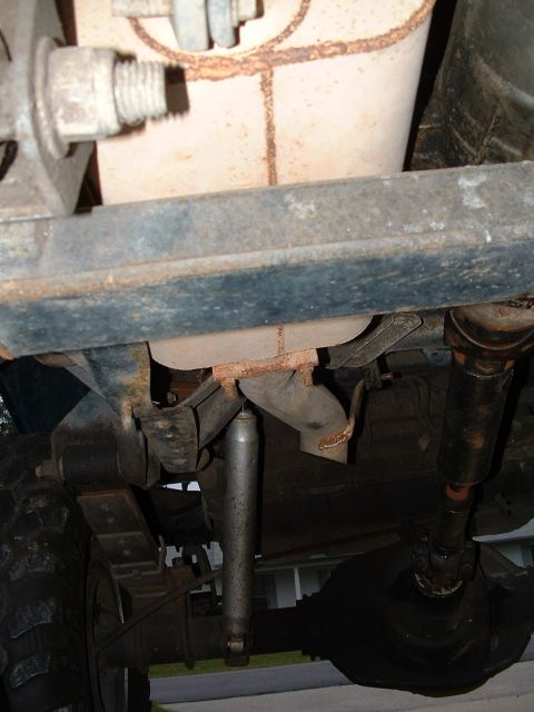 1995 Ford Bronco - Undercarriage components including shock absorber, leaf springs, and exhaust system are visible.