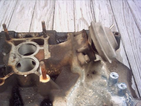 1979 Ford LTD - This intake manifold shows signs of wear and tear, with visible rust on the studs.