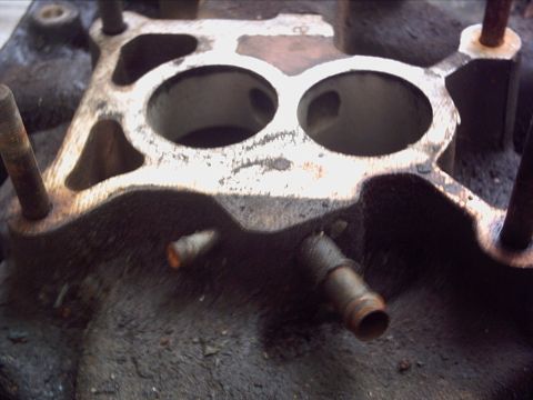1979 Ford LTD - Close-up view of an intake manifold, showing its internal structure and mounting studs.