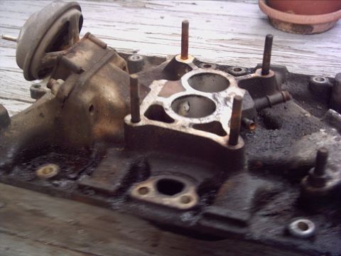 1979 Ford LTD - This is a close-up view of a used engine intake manifold, showing its internal structure and mounting points.