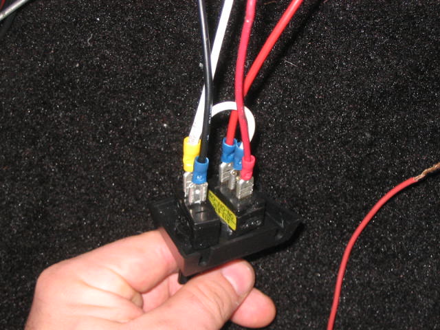 Wires to the back of the switches.  I'm bad about making really messy "Y" connections that look like they'll fall apart and start a fire at any time, so I got an extra box of female spade connectors made for larger wire (the yellow ones) and tried to do things a little nicer this time.  The smaller wire with the red spade connectors is too short for comfort (and also lighter-gauge than the others) and will be replaced one of these days.