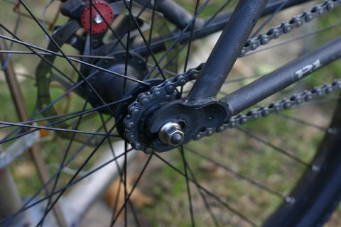 1997 Ford Probe - Close-up of a bicycle's rear drivetrain, showing the chain and wheel spokes.