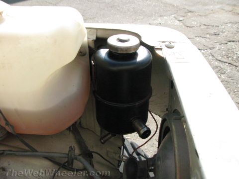 1987 Suzuki Samurai - Close-up view of the power steering fluid reservoir and associated components within a vehicle's engine bay.
